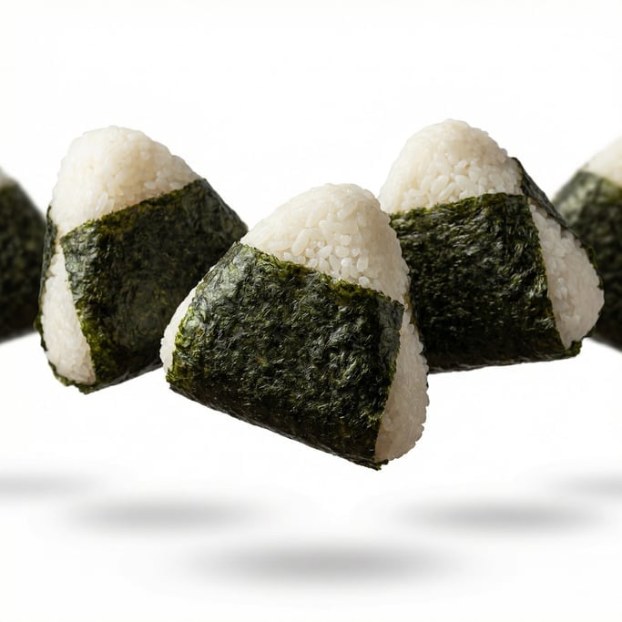 Japanese onigiri rice triangles wrapped in nori, floating in mid-air at a slight angle
