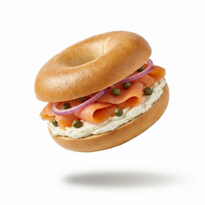 A fresh bagel with cream cheese, smoked salmon, capers, and red onion