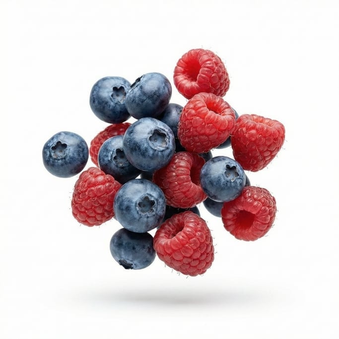 Fresh blueberries and raspberries mixed together, floating in mid-air