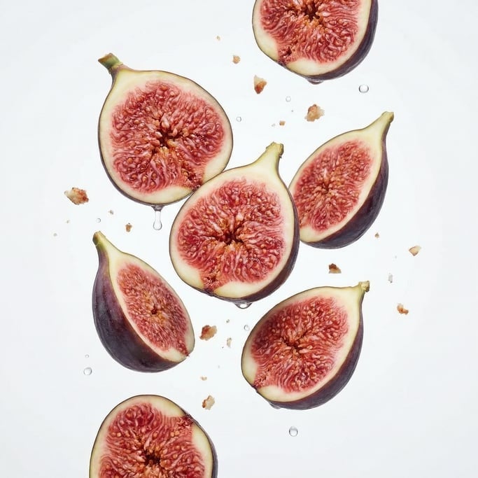 Fresh figs cut in half showing the deep pink interior