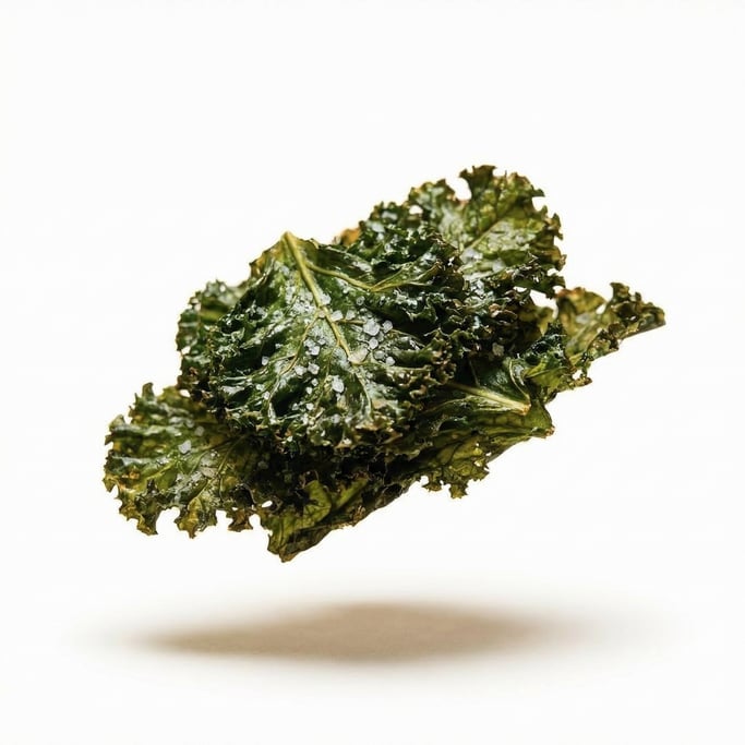 A pile of crispy kale chips with sea salt, floating in mid-air at a slight angle