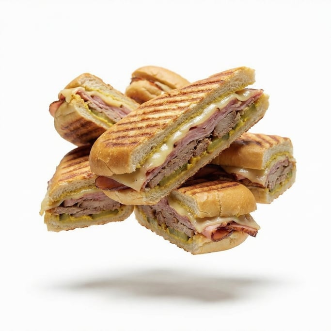 A Cuban sandwich pressed with grill marks showing ham and cheese