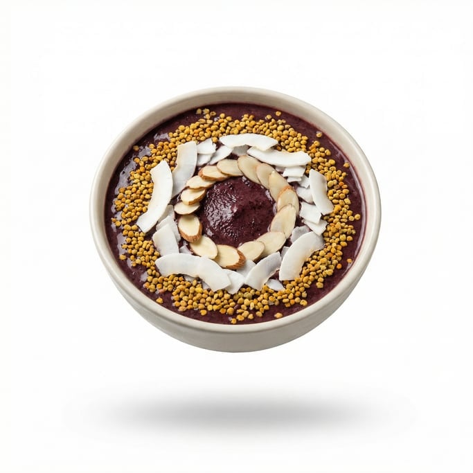 A bowl of acai with bee pollen, coconut flakes, and sliced almonds, floating in mid-air