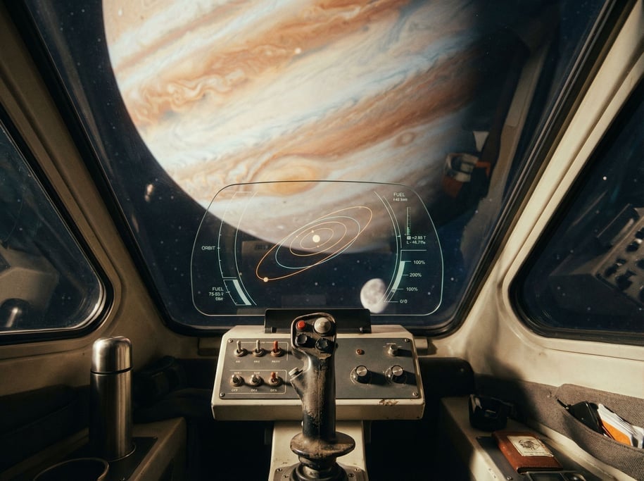 Interior of a spacecraft cockpit from the pilot's perspective — minimal console with a few physical