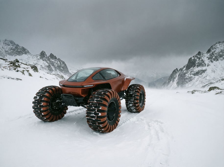 A snow-covered mountain pass with a single futuristic all-terrain vehicle in burnt orange parked at