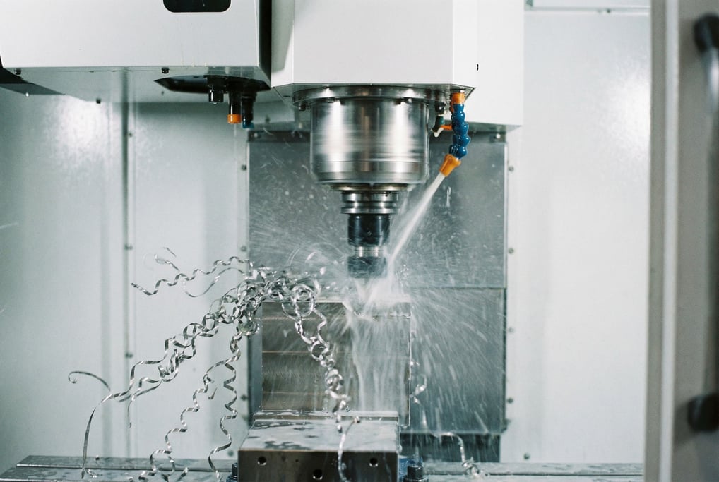 A precision CNC machine mid-cut on a block of titanium, coolant fluid spraying in a fine mist