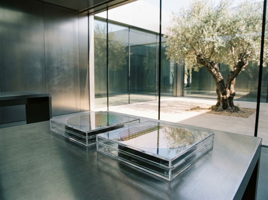 Data wafers in a slim transparent case resting on a brushed titanium desk