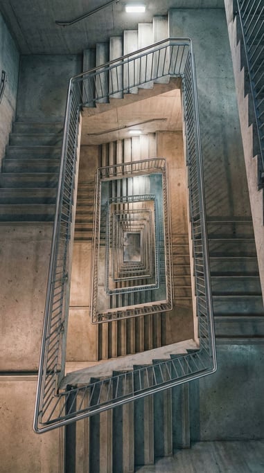 A vertical view of a concrete stairwell from directly above