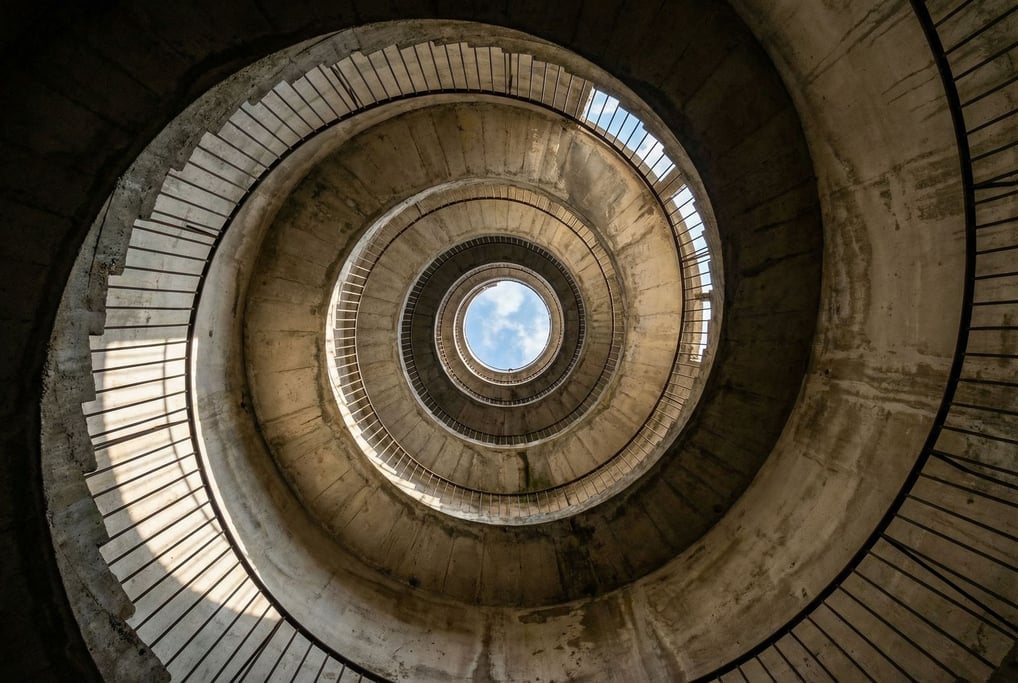 The interior of a concrete tower looking straight up from the ground floor