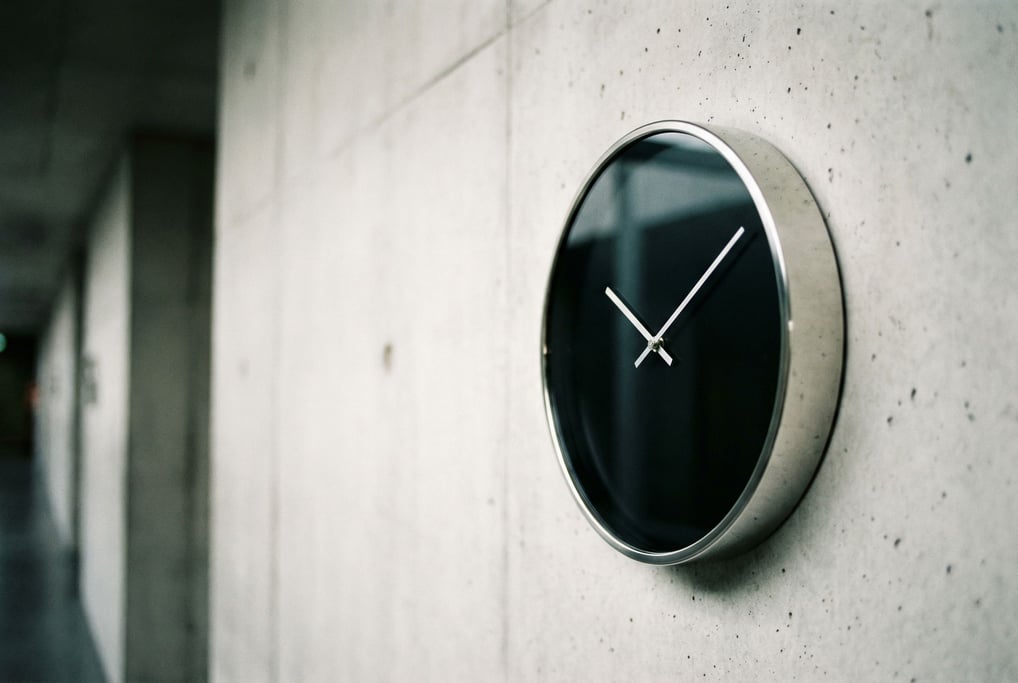 A precision clock on a concrete wall
