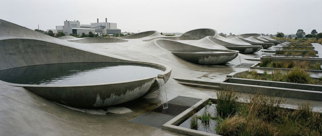 A concrete skate park-like landscape — smooth curved surfaces, bowls