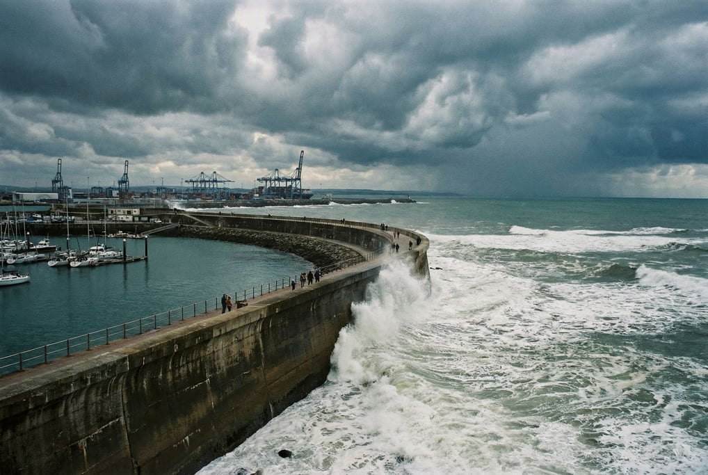 A concrete seawall curving along a bay