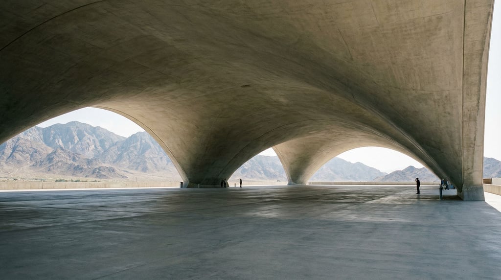 A catenary-curved concrete roof over an outdoor assembly area