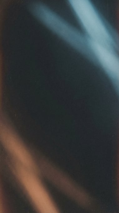 Moody film grain gradient, deep charcoal background with soft opposing diagonal glows of arctic blue