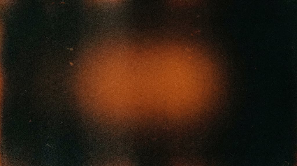 Dark grainy gradient abstract, deep black canvas with a soft centered glow of warm persimmon orange