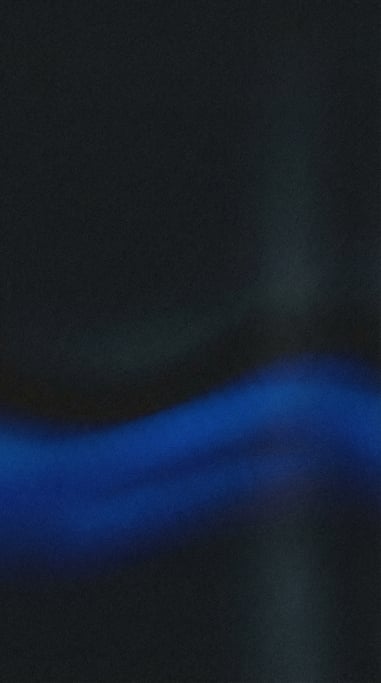 Dark grainy gradient abstract, near-black background with a sweeping horizontal band of deep cobalt