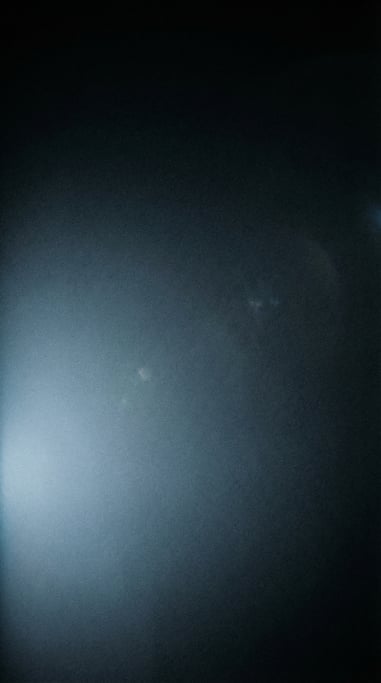 Moody dark gradient atmosphere, black background with a diffused glow of cool steel blue at the lowe