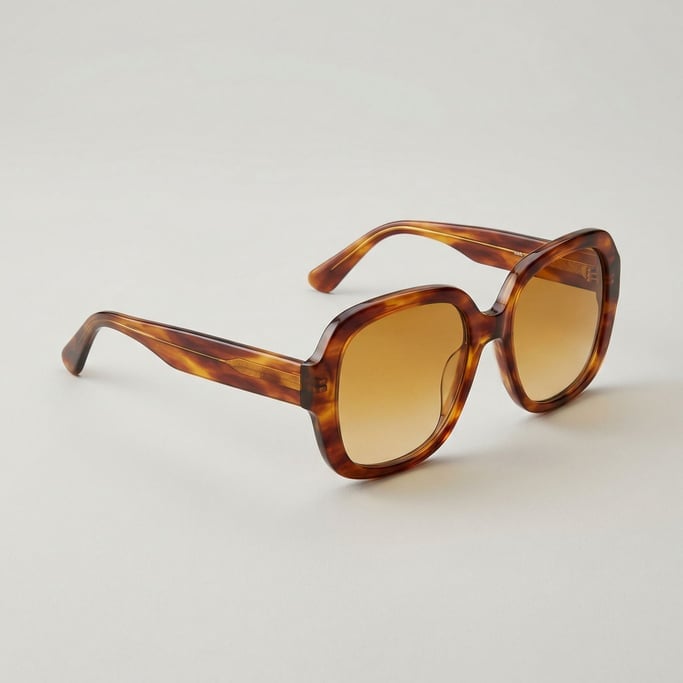 Oversized tortoiseshell acetate sunglasses with amber gradient lenses, polished temple arm tips