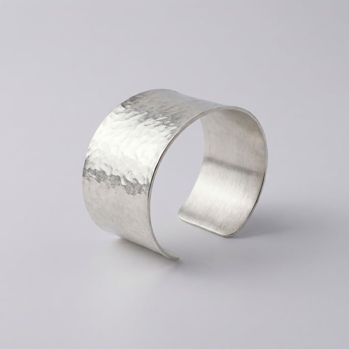 Statement cuff bracelet in hammered sterling silver with a wide band and a brushed matte interior fi
