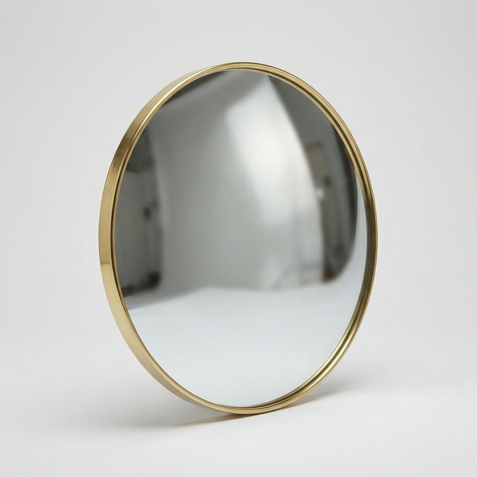 Round convex mirror with a thin polished brass frame and a slightly distorted wide-angle reflective
