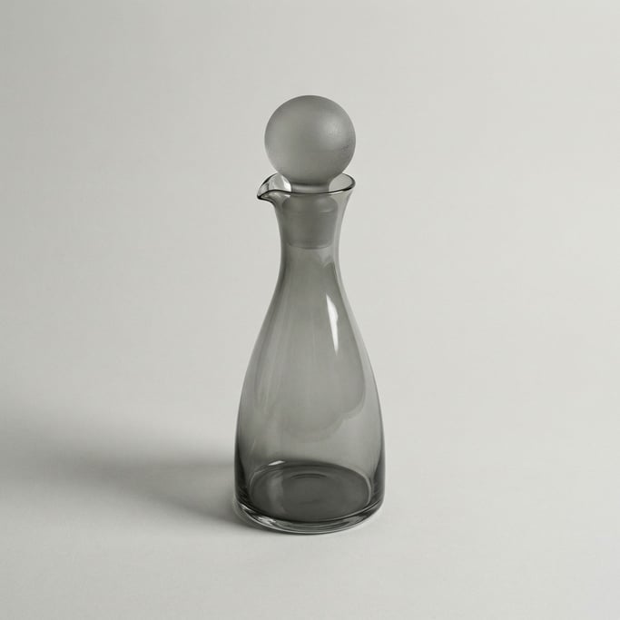 Smoked grey glass carafe with a spherical ground-glass stopper and a graceful tapered neck with pour