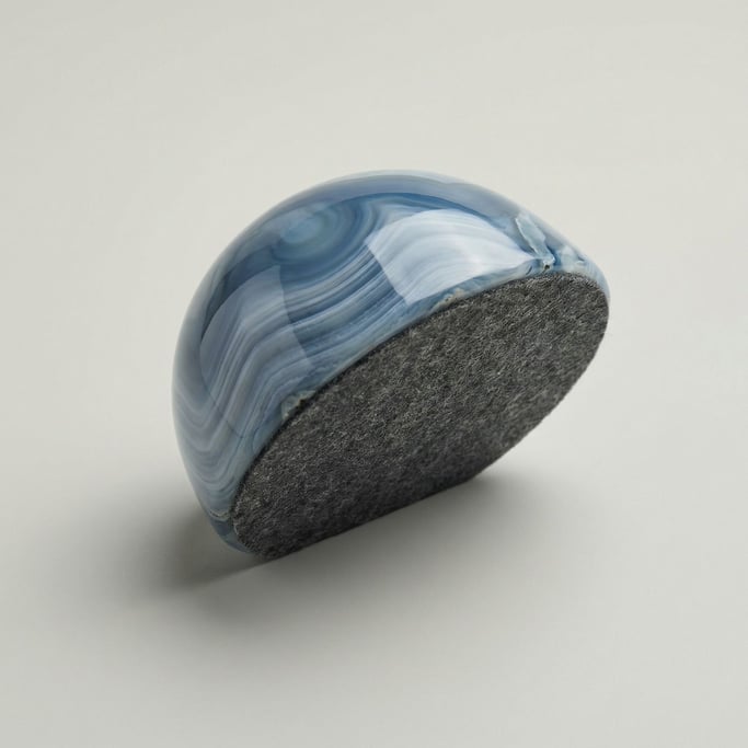 Polished blue-and-white banded agate paperweight with a smooth domed top
