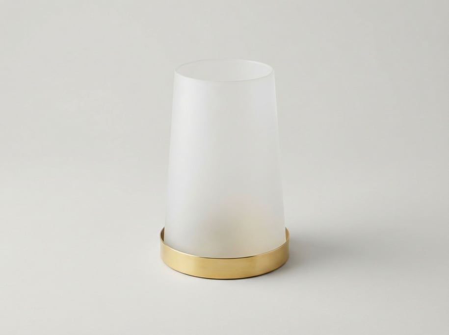 Frosted glass hurricane candle holder with a polished brass base ring and a tapered cylindrical silh