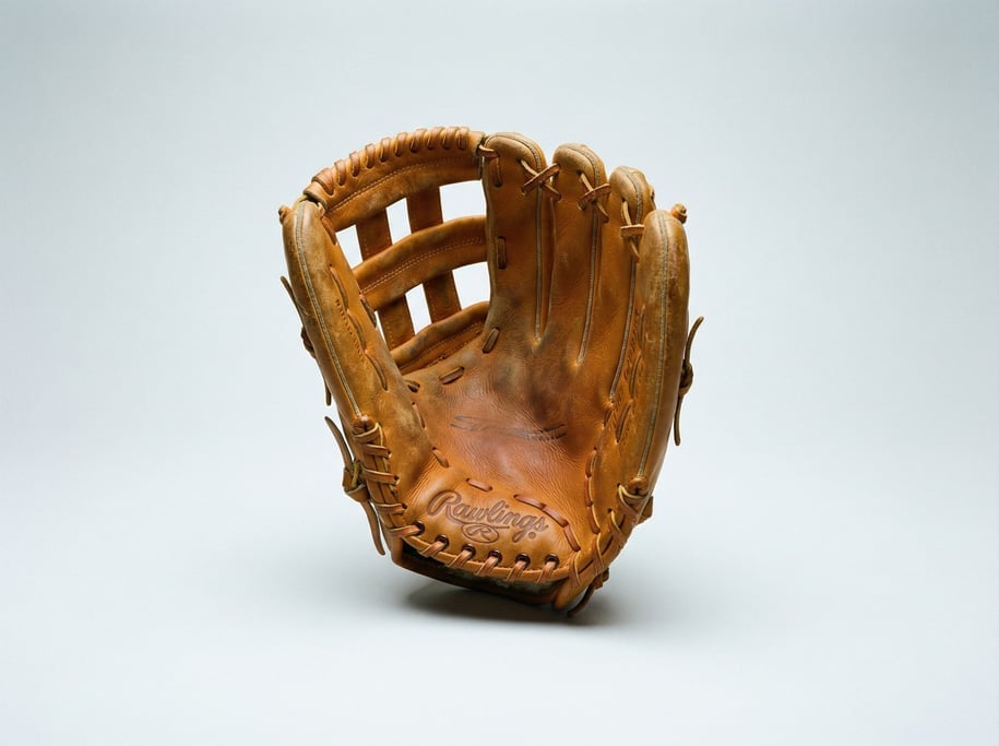 Leather baseball glove in warm butterscotch steerhide with a deep web pocket, visible stitching