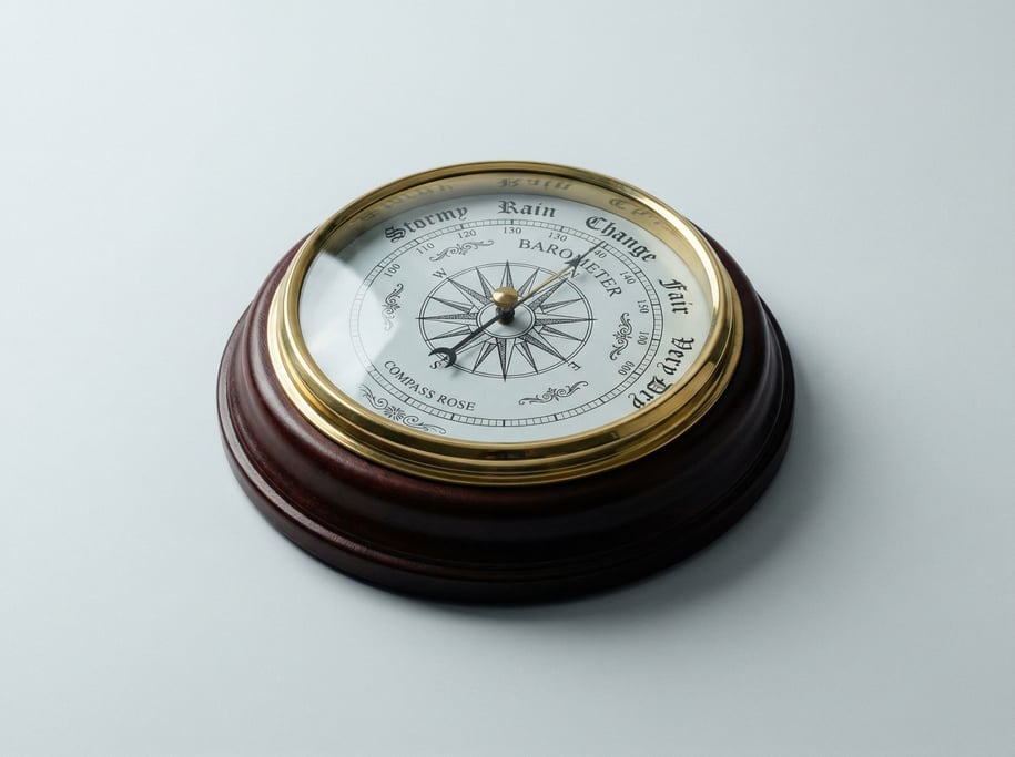Vintage compass rose wall barometer in dark mahogany with a brass bezel, glass face