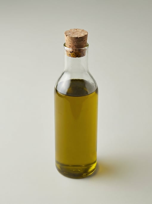 Tall glass oil cruet with a natural cork stopper, narrow neck