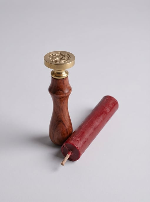Wax seal kit with a turned rosewood stamp handle and a stick of deep red traditional sealing wax wit
