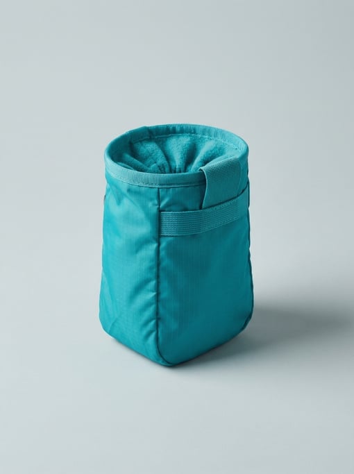 Rock climbing chalk bag in bright teal ripstop nylon with a drawstring fleece-lined opening and a we