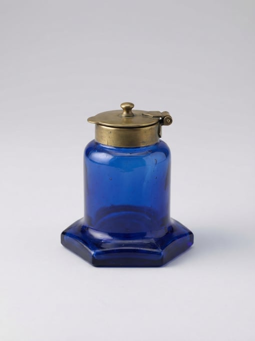 Old-fashioned ink well in cobalt blue blown glass with a brass hinged flip lid and a wide stable hex
