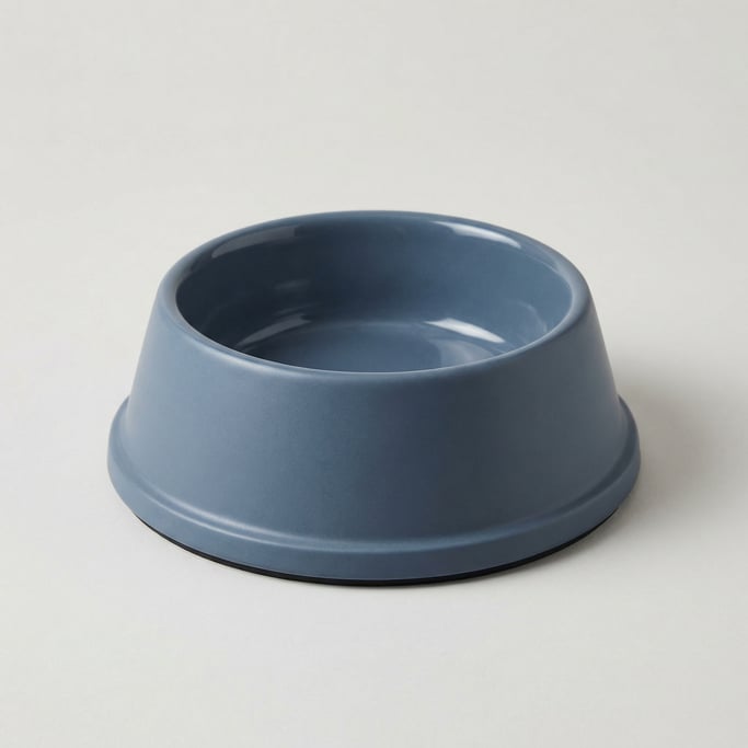Ceramic pet food bowl in matte slate blue with a wide non-slip base, gently sloped sides