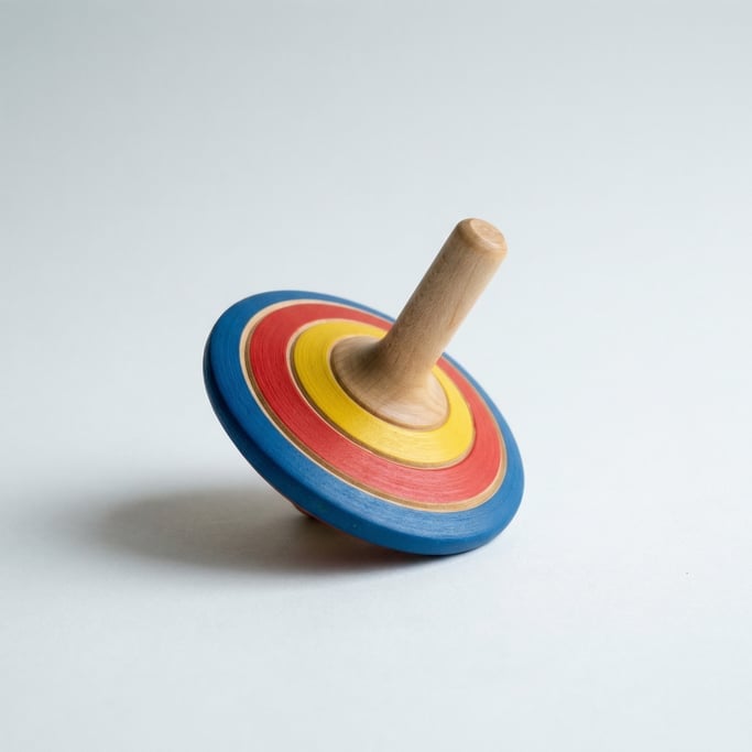 Colorful wooden spinning top with concentric painted rings in blue, red