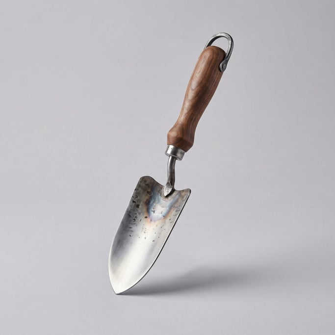 Hand-forged garden trowel with a stainless steel blade, riveted walnut handle