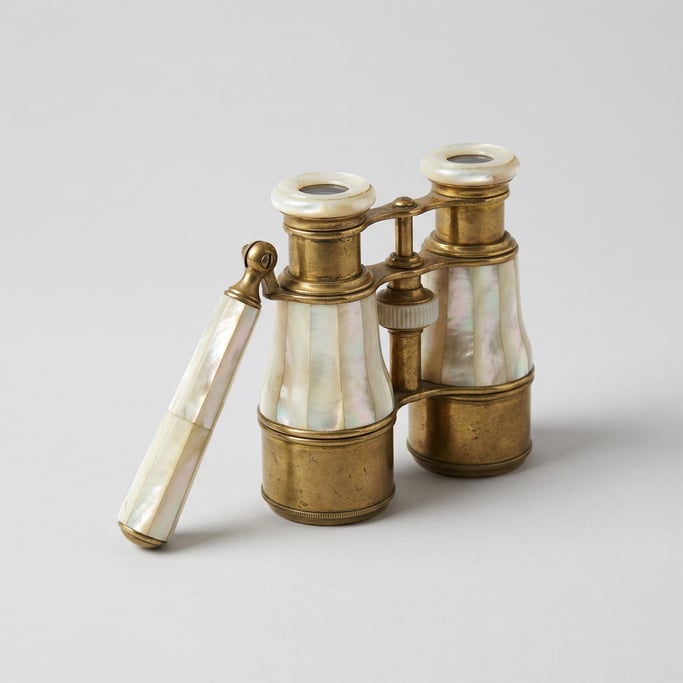 Mother-of-pearl opera glasses in ivory nacre shell with telescoping brass barrels and a folding lorg