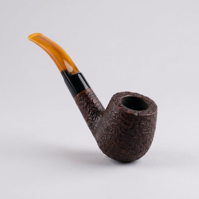 Hand-carved briar pipe with a bent billiard shape, rusticated bowl texture, vulcanite stem