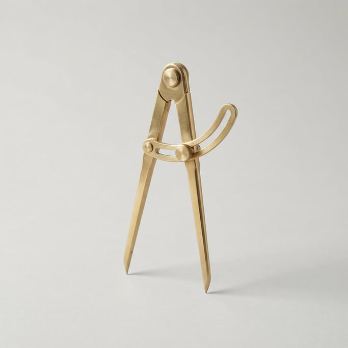 Brass divider calipers with two pointed legs, a friction-hinge joint