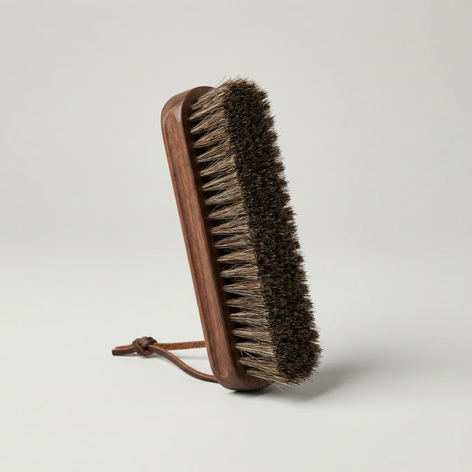 Natural horsehair clothes brush with a dark walnut handle, dense bristle rows