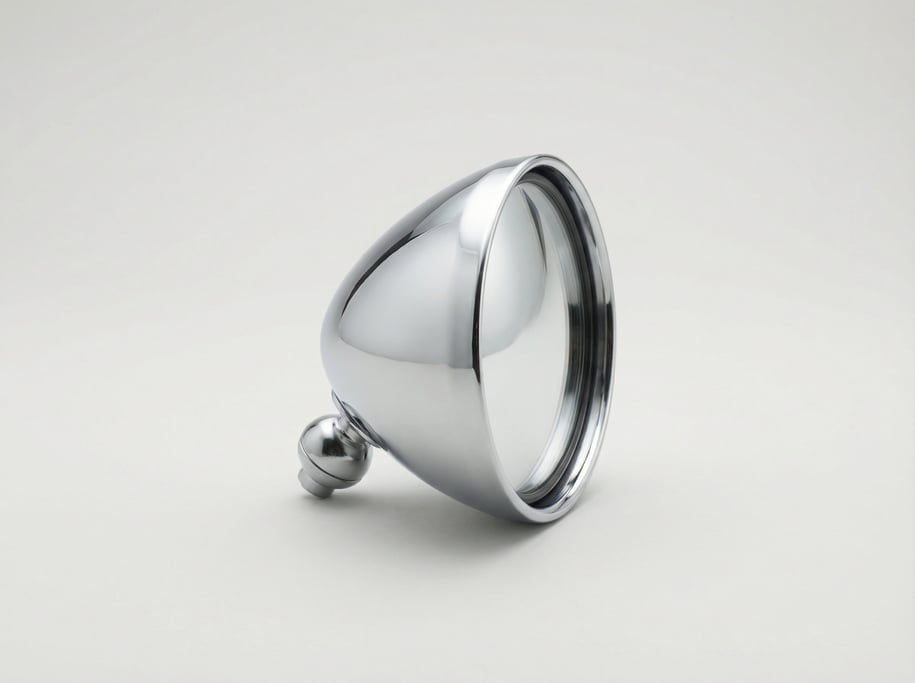 Chrome side-view mirror housing with a convex glass lens, aerodynamic teardrop shell shape