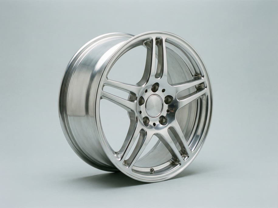 Polished aluminum alloy wheel rim with a five-spoke split design, drilled lug nut holes