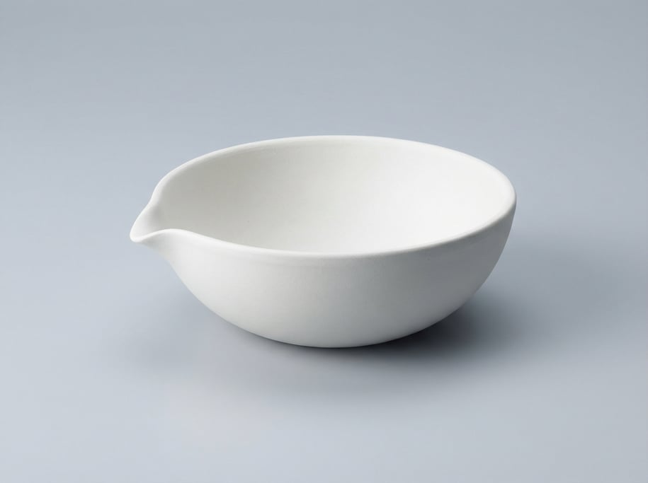 Porcelain evaporating dish in unglazed white with a wide shallow bowl, angled pour spout