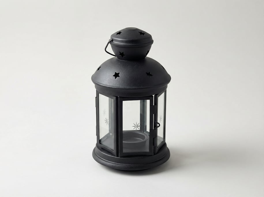 Cast iron candle lantern in matte black with clear glass panes, a hinged access door
