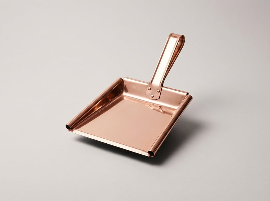 Copper dustpan in polished rose gold with a flat scoop lip, riveted handle