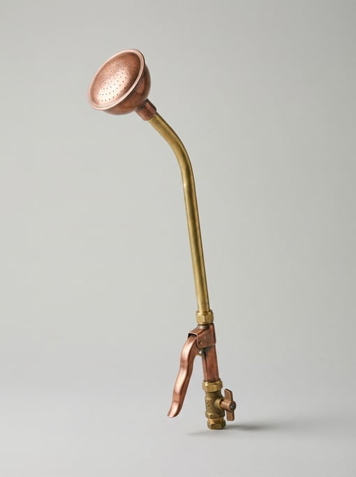 Copper watering wand with a gentle shower rose head, long curved brass tube
