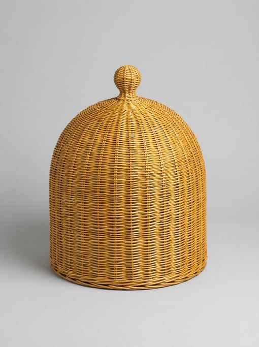 Woven willow plant cloche in natural golden wicker with an arched dome shape and a decorative finial