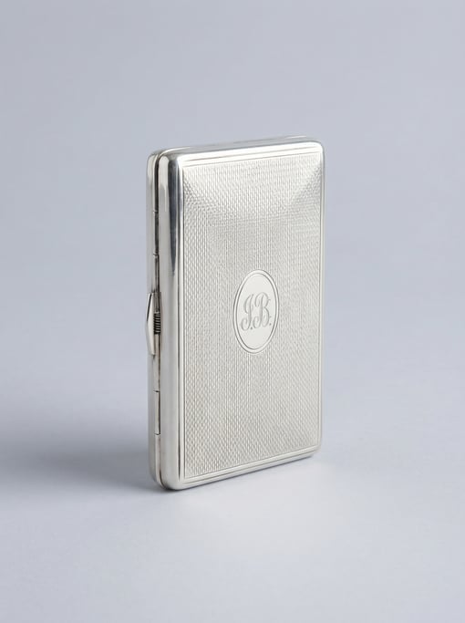 Silver-plated cigarette case with an engine-turned guilloche pattern lid