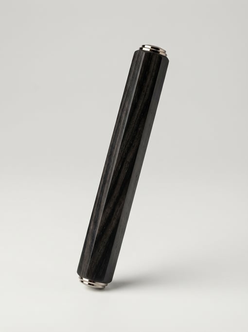 Ebony wood pen blank in deep black with visible grain streaks, octagonal turned barrel shape
