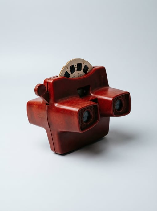 Vintage View-Master stereoscope viewer in red Bakelite plastic with a lever arm